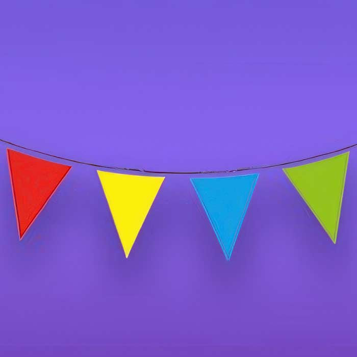 Vibrant colourful bunting in bright red, yellow, blue, and green for festive celebrations and outdoor events